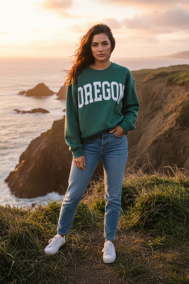 Forest green "OREGON" graphic sweatshirt with coastal cliff background