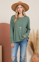 Ash jade green sweater on model with improved background
