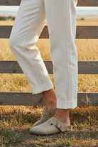 Beige buckle clogs with western boho ranch background - closer view