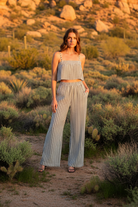 Black and white striped wide-leg pants with desert landscape