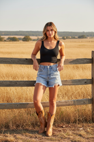 Black ribbed crop tank with denim shorts and western boho ranch background