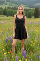 Black sleeveless romper with mountain meadow background