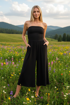 Black strapless jumpsuit with mountain meadow background