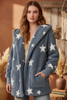 Blue-gray fuzzy sherpa jacket with white stars on model