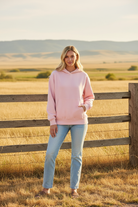 Blush pink oversized hoodie without drawstring and western boho ranch background
