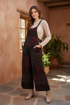 Burgundy and green tie-dye jumpsuit on model with styled background