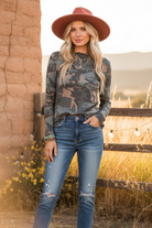 Camo long sleeve top on model with styled background