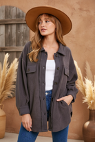 Charcoal shacket on model with styled background