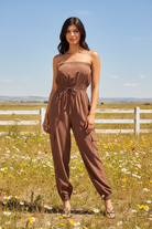 Chocolate brown strapless cargo jumpsuit in bright boho western setting