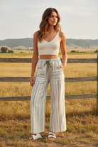 Cream and grey striped wide leg pants with cargo pockets and western boho ranch background