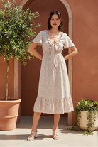 Cream floral midi dress with terracotta backdrop