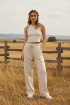 Cream wide leg cargo sweatpants with western boho ranch background