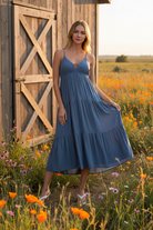 Dusty blue tiered cami midi dress with rustic barn wildflower meadow background