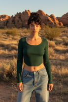 Forest green ribbed crop top with puff sleeves and desert landscape