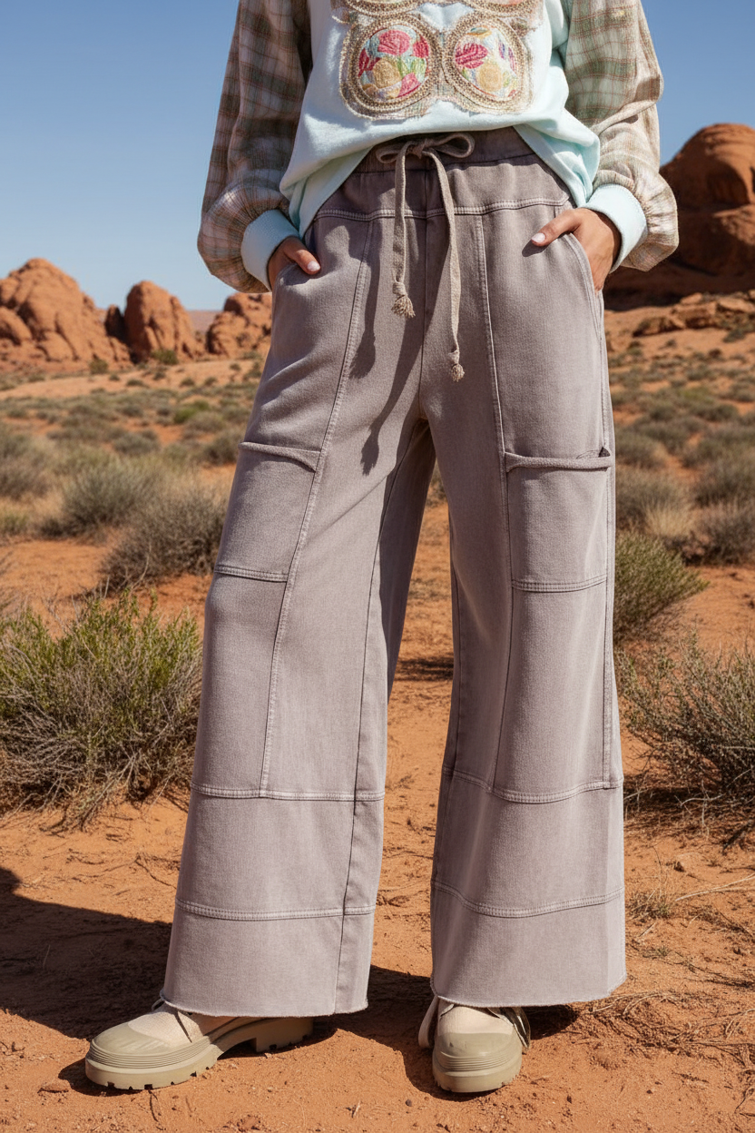Gray cargo wide leg pants with contrast stitching and desert landscape