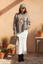 Gray star sweater with southwestern background