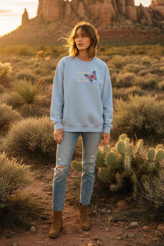 Light blue butterfly sweatshirt with desert landscape