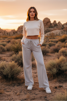 Light gray wide-leg drawstring pants with desert landscape - full body