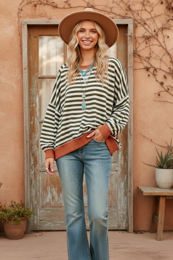 Olive green and cream striped sweater with rust trim on model