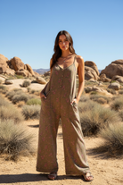 Olive green floral print wide leg jumpsuit with desert landscape