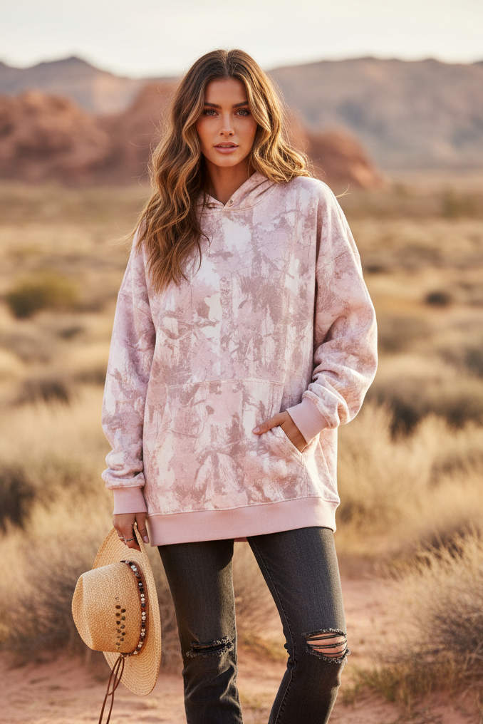 Pink camo hoodie on model with outdoor background