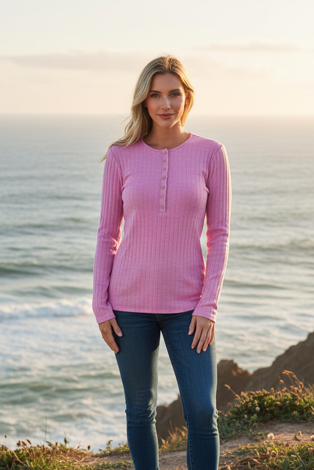 Pink ribbed henley long sleeve top with coastal cliff background