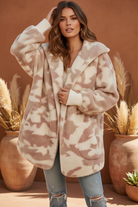 Taupe and cream camo fuzzy fleece jacket on model with styled background