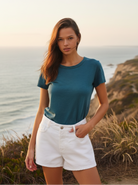 Teal distressed short sleeve tee with coastal cliff background