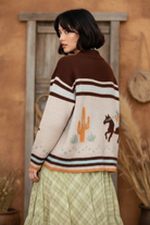Western horse sweater on model with styled background