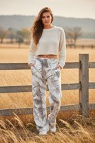 White camo print wide leg sweatpants with western boho ranch background