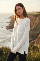 White distressed long sleeve tee with coastal cliff background - closer view