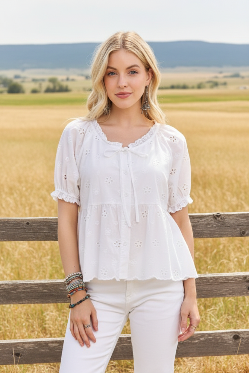 White eyelet peasant top with tie neckline and western boho ranch background